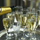 Champagne being poured into flutes on a silver tray